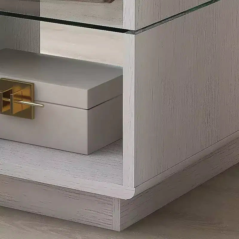 Table d'appoint moderne avec plateau en verre trempé et base de rangement.